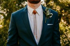 a man in a suit with a boutonniere on his lapel