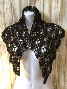 Super soft and glittery hand crocheted black shawl for child. Great gift for Halloween, birthday or any occasion for a daughter, niece or any lucky child. I hand crocheted this wrap using sequined fine black glitter yarn and a size G crochet hook using a pattern called Anna by Katya Novikova (https://www.lovecrafts.com/en-us/p/anna-crochet-pattern-by-katya-novikova). The shawl measures 42.5 inches across the top and 18 inches top to bottom and contains alternate rows of lace arches and shells, d Black Winter Party Shrug, Winter Party Black Shrug, Fitted Black Shawl For Party, Black Party Shawl, Handmade Black Shawl For Winter, Handmade Shawl In One Size - Perfect For Gifts, Hand Knitted Shawl As Winter Gift, Hand Knitted Shawl For Winter Gift, Hand Knitted Shawl Gift For Winter