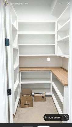 an empty walk in closet with boxes on the floor