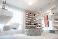 a white room with shelving and shoes on the floor