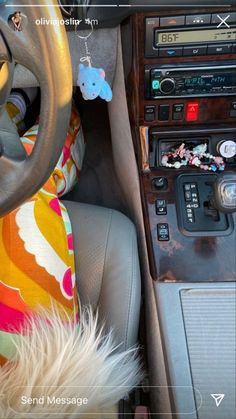 the interior of a car with an animal keychain hanging from it's center console