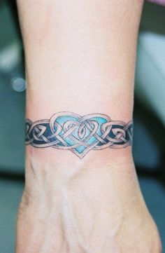 a woman's foot with a tattoo on the side of her leg and an intertwined