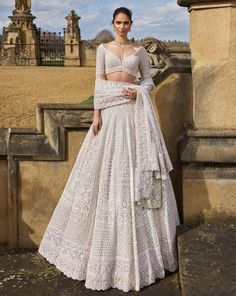 This nude lehenga set features intricate embroidery in thread, pearl, and sequin in a geometric pattern. The fully embroidered blouse has exaggerated tassels at the elbow. The dupatta has four sided heavy embroidery with a geometric jaal in the center.From Seema Gujral's A Royal Affair collection. DELIVERY TIMEPlease allow 8-12 weeks for your outfit to arrive. FABRIC DETAILSNet Professional cleaning only. Wedding Lengha Bridal Lehenga, Nude Lehenga, Pearl Lehenga, Pearl Tassels, Seema Gujral, A Royal Affair, White Lehenga, Lehenga Dupatta, Indian Bridal Photos