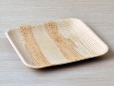 a wooden plate sitting on top of a table