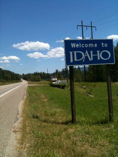 a welcome to idaho sign on the side of the road