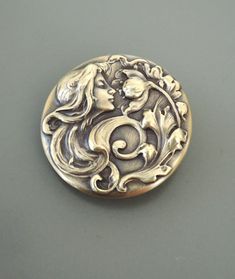 "Vintage Brooch - Art Nouveau Jewelry - Mucha Woman Brooch - Brass jewelry - Chloes Vintage Jewelry - handmade jewelry This is an exquisite piece! A gorgeous vintage brass brooch of an Art Nouveau Mucha Women smelling a poppy. Remarkable detail with a rich patina. Chloe says, \"Wear it and feel fabulous!\" The brooch measures 1 1/2\" wide. Thanks for visiting Chloe's" Art Nouveau Mucha, Button Collecting, Instruments Art, Bijoux Art Nouveau, Brooch Art, Vintage Inspired Earrings, Nouveau Jewelry, Bainbridge Island, Dainty Tattoos