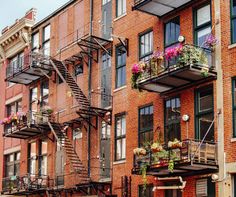 an apartment building with several balconies and flowers on the balconys in new york city