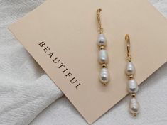 Add a touch of luxury to your everyday style with these handmade pearl hook earrings. Featuring beautiful irregular teardrop pearls, sparkling cubic zirconia, and luxurious gold vermeil findings, these earrings are perfect for dressing up any outfit. D E T A I L S *  Gold Vermeil. *  Pearl is genuine freshwater teardrop baroque pearl. *  Pearl measures 6-9 mm. *  Tarnish-free and safe for sensitive skin. *  Sold as a pair. C R A F T I N G  *  S H I P P I N G *  We handcraft each piece to order, so please allow 3-5 business days for processing before shipment. *  Orders typically ship via USPS First Class Mail and arrive within 2-5 business days within the US.  R E T U R N  *  E X C H A N G E *  We want you to be completely satisfied with your purchase. If for any reason you are not happy w Elegant Handmade Teardrop Linear Earrings, Elegant Long Drop Baroque Pearl Earrings, Teardrop Baroque Pearl Earrings For Everyday, Everyday Teardrop Baroque Pearl Earrings, Elegant Baroque Pearl Earrings For Everyday, Everyday Dangle Earrings With Baroque Pearl, Everyday Baroque Pearl Dangle Earrings, Baroque Pearl Long Drop Earrings As Gift, Baroque Pearl Long Drop Earrings For Gift