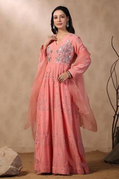 Pink long anarkali with floral embroidery. Comes with organza dupatta.
Components: 2
Pattern: Embroidered
Type Of Work: Sequins, Pearls, Cutdana
Neckline: V Neck
Sleeve Type: Full
Fabric: Anarkali: Chanderi, Dupatta: Organza
Color: Pink
Other Details: 
Attached lining
Approximate product weight: 0.5-1 kg
Occasion: Puja - Aza Fashions Semi-stitched Anarkali Salwar Kameez For Reception, Anarkali Gown With Mirror Work, Semi-stitched, Festive Anarkali Gown With Chikankari Embroidery, Anarkali Style Semi-stitched Salwar Kameez For Reception, Semi-stitched Anarkali Gown In Dola Silk, Semi-stitched Floor-length Anarkali Set With Chikankari Embroidery, Festive Floor-length Anarkali Set With Chikankari Embroidery, Embroidered Anarkali Set Maxi Length, Anarkali Gown With Sheer Dupatta In Chinon