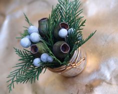 a small vase filled with green and white balls on top of a tablecloth covered floor