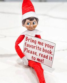 an elf holding a sign that says bring me your favorite book please read it to me