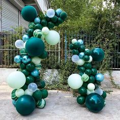 two large green and white balloons in the shape of letters