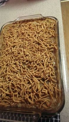 a casserole dish filled with noodles on top of a counter