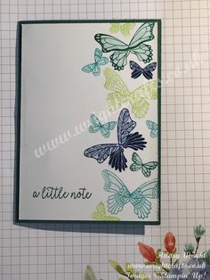 a close up of a card with butterflies on it