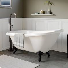 a white bath tub sitting on top of a bathroom floor