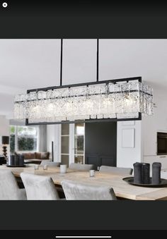 a chandelier hanging over a dining room table