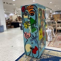 a colorful box sitting on top of a blue rug in a room filled with furniture