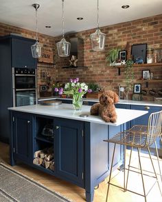 a teddy bear sitting on top of a kitchen island