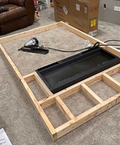 a large wooden frame sitting on top of a carpeted floor