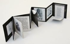 an open book with pictures inside it on a white surface, and the pages are folded in half