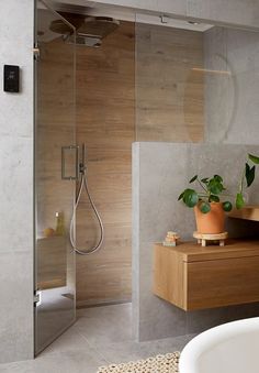 a bathroom with a tub, sink and shower head in it's center wall