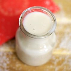 a glass jar filled with milk sitting on top of a table