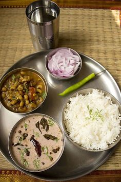 a metal plate topped with different types of food