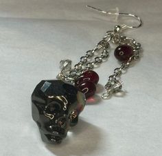 These spooky skull earrings add a gothic touch to any outfit.  Whether accessoring for daily outfits or channeling your Halloween spirit, these earrings will be sure to stand out Alternative Style Halloween Gift Earrings, Gothic Skull Earrings For Party, Punk Skull Earrings For Party, Gothic Skull Earrings For Halloween, Black Gothic Earrings With Skull Print, Gothic Skull Print Earrings For Gift, Gothic Skull Print Earrings As Gift, Edgy Skull Earrings For Parties, Gothic Skull Earrings