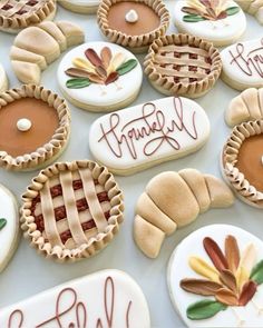 many decorated cookies are sitting on a table with the words happy friday written in cursive writing