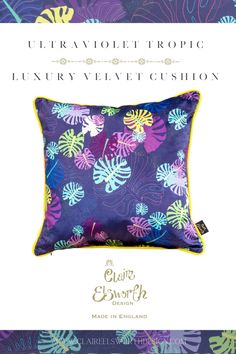 the luxury velvet cushion is shown in purple and blue with tropical leaves on it's sides