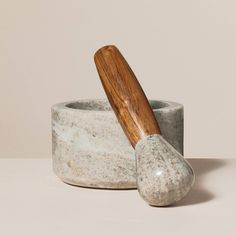 a wooden spoon sitting next to a ceramic cup