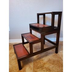 a set of three wooden stools sitting on top of each other