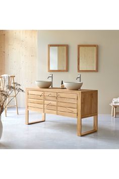 a bathroom with two sinks and mirrors on the wall