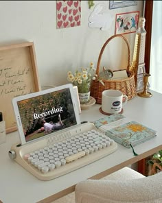 a laptop computer sitting on top of a desk next to a white keyboard and mouse