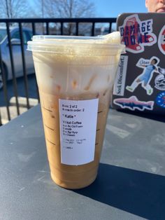 a cup of iced coffee sitting on top of a table