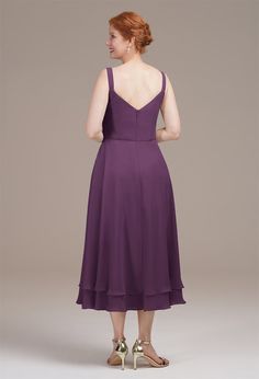 a woman in a purple dress is looking back