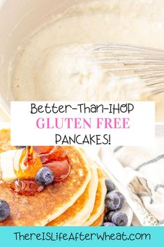 a stack of pancakes with blueberries and butter on top, next to a bowl of gluten