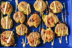 some food is sitting on a blue tray and drizzled with icing