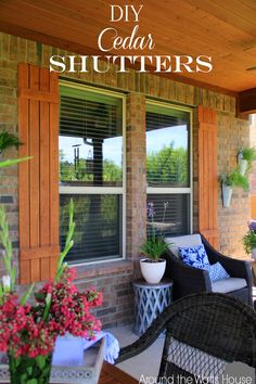 the front porch is decorated with flowers and plants