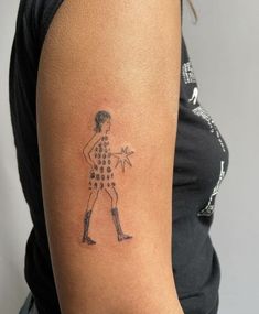 a woman's arm with a tattoo on it that has a drawing of a person holding a star