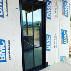 an open door on the side of a building under construction with blue blvd signs