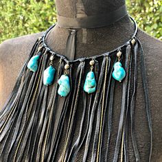 "-This bohemian bib necklace features soft black deerskin leather and turquoise howlite stones, accented by pyrite stones. -A versatile statement piece, this fringe necklace is equally stunning as festival wear, western wear, resort wear, or paired with your little black dress. -The collar is adjustable from 15\" - 17\" with a 2\" adjuster chain in the back. Longer adjuster chain available by request. -Leather fringe hangs 7\" from the collar. -Also available in rust-color leather. -Designed and Bohemian Adjustable Black Turquoise Necklace, Blue Leather Jewelry For Festivals, Bohemian Black Leather Necklace, Boho Style Bracelets, Diy Leather Earrings, Bison Leather, Handmade Crystal Jewelry, South Pasadena, Black Turquoise