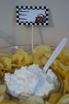 a bowl filled with chips next to a sign