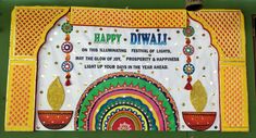 a sign that says happy diwali on the side of a building with colorful decorations