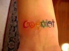 a person with a tattoo on their wrist that says cozetter in multicolored letters