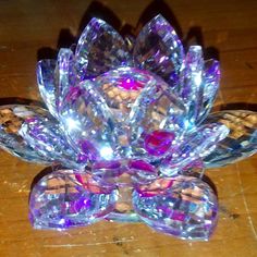 a crystal flower is sitting on a wooden table