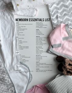 the newborn essentials list is laid out on top of blankets and other baby items