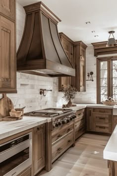 a large kitchen with wooden cabinets and white counter tops is pictured in this image, there are two ovens on either side of the stove