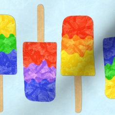 three popsicles made out of paper and colored ice lollies on top of each other