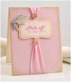 a card with a pink ribbon on it